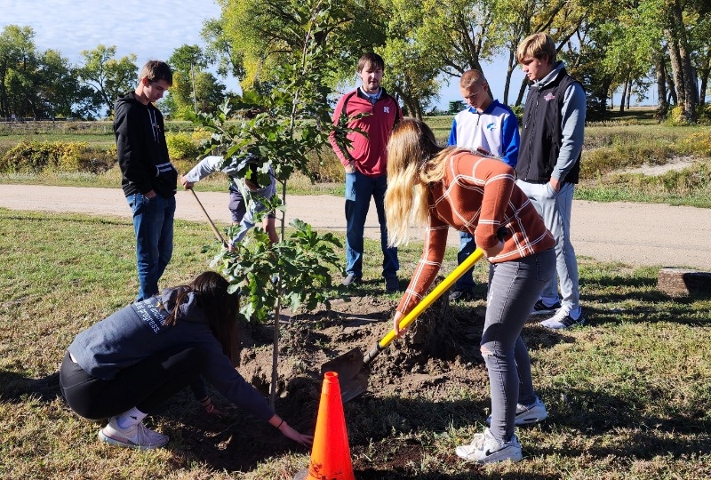 West Holt Public Students from the freshman agriculture class plant a tree at Atkinson Mill Race Park.