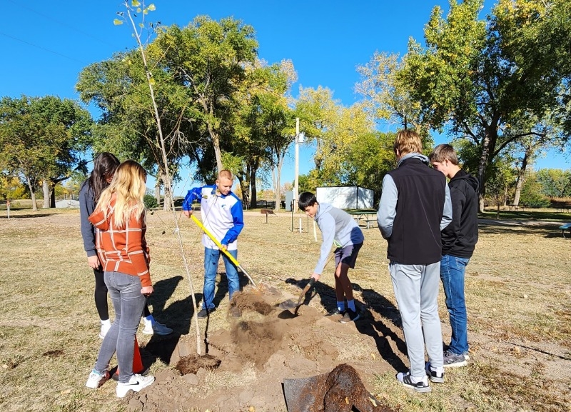 West Holt Public Students from the freshman agriculture class plant a tree at Atkinson Mill Race Park.