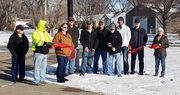 Officials from City of Atkinson, GenPro Energy and Central Nebraska Economic Development cut the ribbon in front of one of the recently installed solar lights.